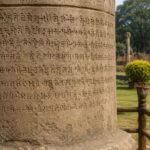 Stone inscription representing Ashoka edicts and ancient Indian manuscripts